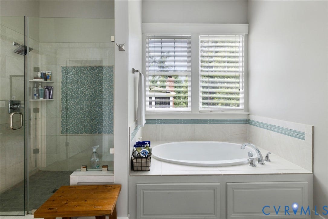 15918 Drumone Road, Hallsley, Midlothian, VA 23112 Built-in soaking tub with paneled surround, dual windows, and a tiled shower with glass enclosure