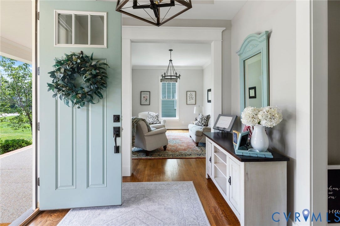 15918 Drumone Road, Hallsley, Midlothian, VA 23112 Light blue paneled entry door with transom window and matte black hardware opens to a foyer with wood-finish flooring