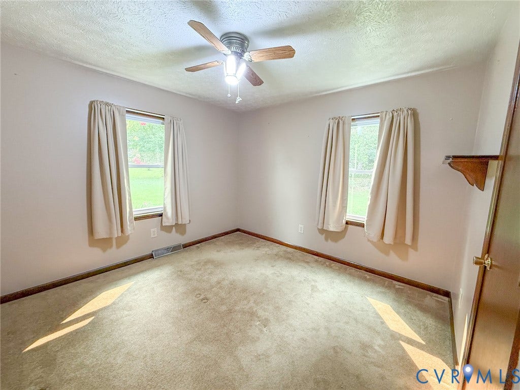 6688 Old Buckingham Road, Powhatan, VA 23139 Room with two windows, a ceiling fan with light fixture, and light-colored carpeting