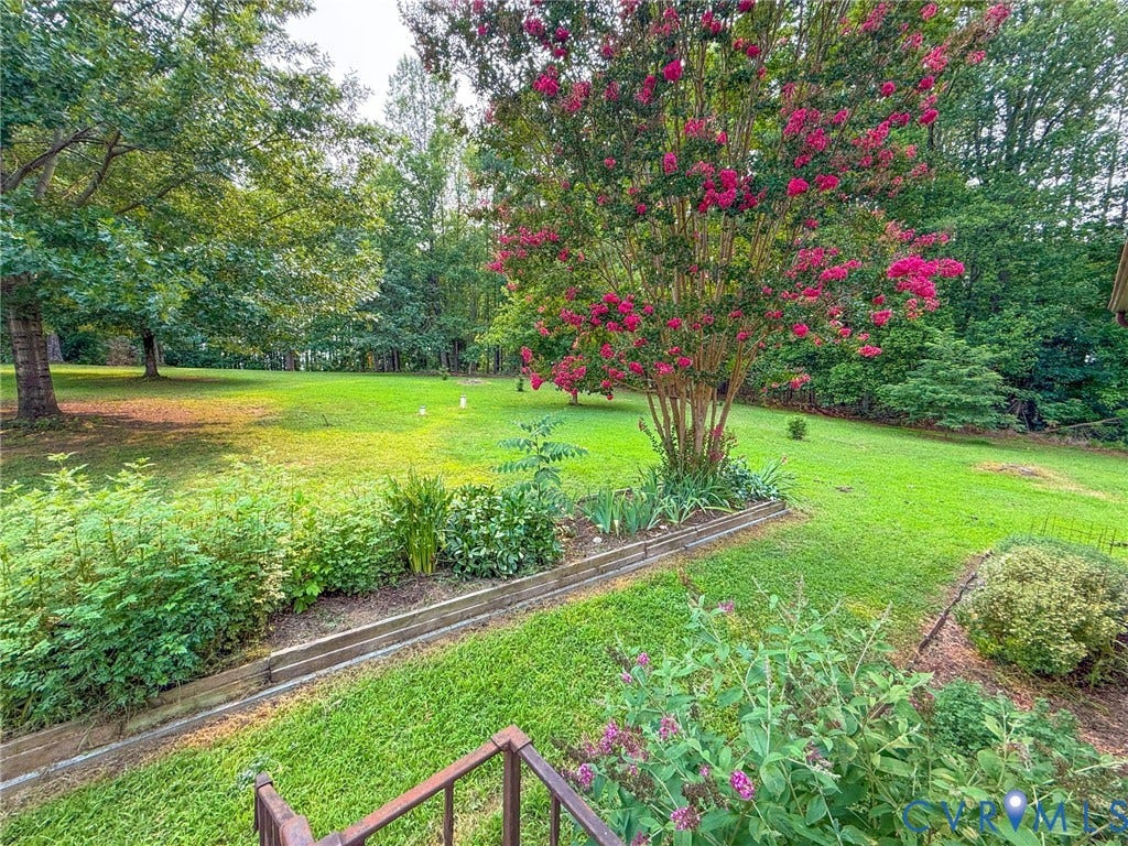 6688 Old Buckingham Road, Powhatan, VA 23139 Expansive green lawn with mature trees and vibrant flowering shrubs