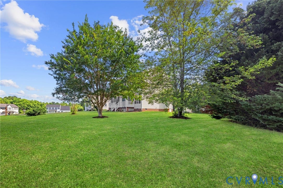 5025 Alberta Mews, Chesterfield, VA 23832 Expansive rear lawn featuring mature trees and established landscaping. Virtually edited grass
