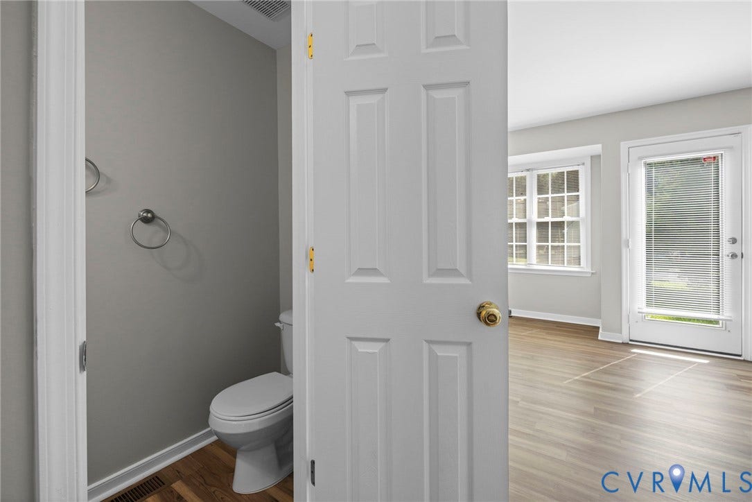 5025 Alberta Mews, Chesterfield, VA 23832 Powder room entry featuring LVP flooring, a white toilet, and gray wall paint