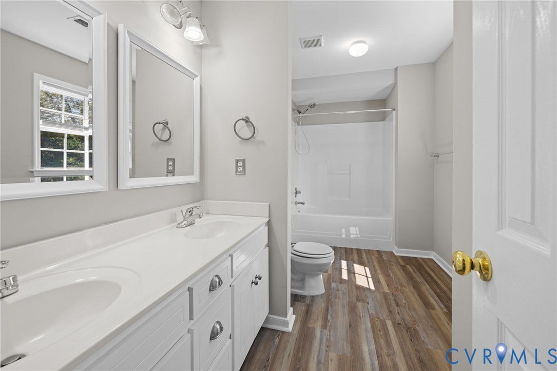 5025 Alberta Mews, Chesterfield, VA 23832 Bathroom featuring a double vanity with integrated sinks, white cabinetry, and wood-finish flooring