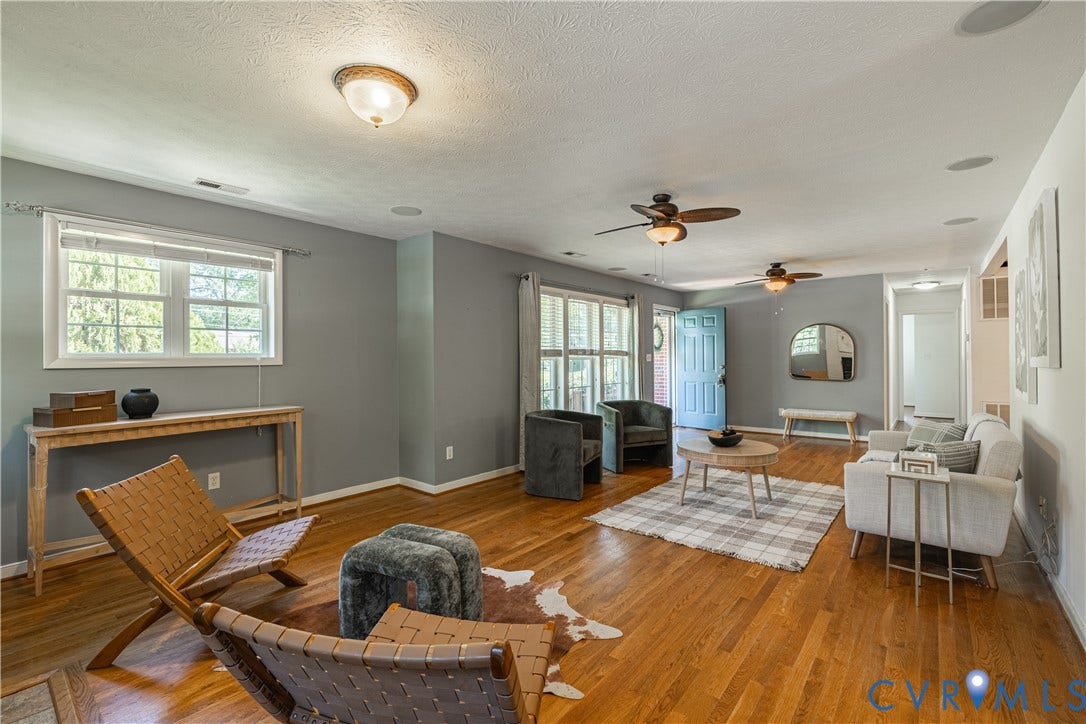 704 Forestview Drive, Colonial Heights, VA 23834 Expansive living area featuring hardwood flooring, recessed ceiling speakers, and multiple ceiling fans