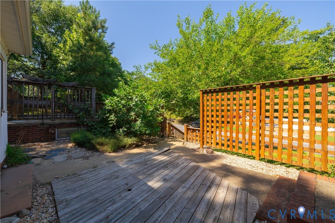 704 Forestview Drive, Colonial Heights, VA 23834 Tiered outdoor space featuring a lower wood-plank deck, an upper wood deck with balusters, and a lattice wood privacy fence