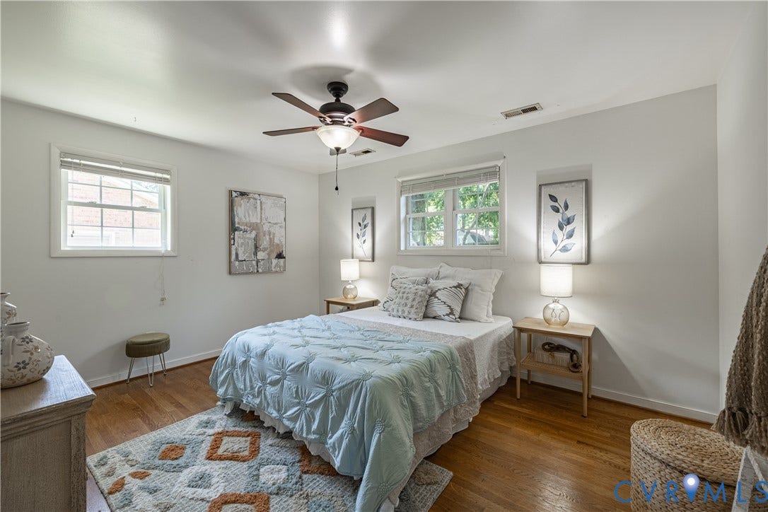 704 Forestview Drive, Colonial Heights, VA 23834 Bedroom featuring wood-finish flooring, white walls, and two windows with blinds