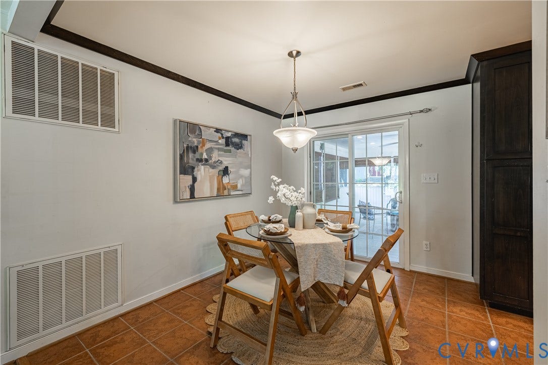 704 Forestview Drive, Colonial Heights, VA 23834 Dining area featuring tile flooring, dark wood crown molding, a sliding glass door, and built-in cabinetry