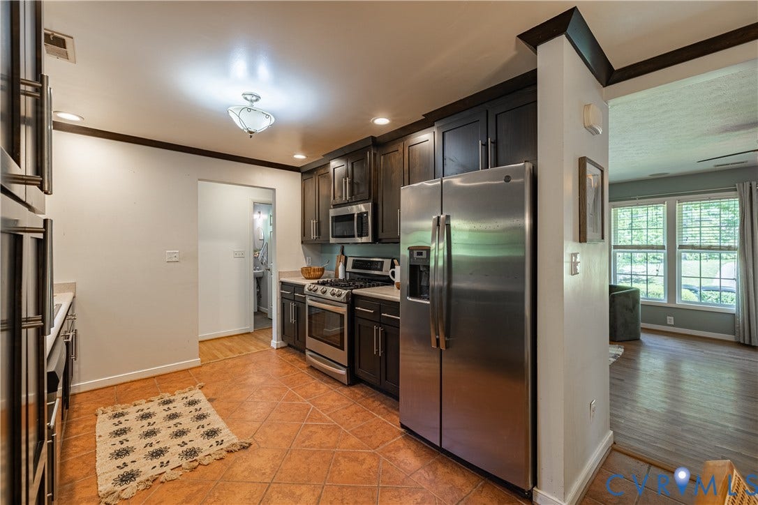 704 Forestview Drive, Colonial Heights, VA 23834 Kitchen featuring dark wood cabinetry, stainless steel appliances, and terracotta-style floor tiling