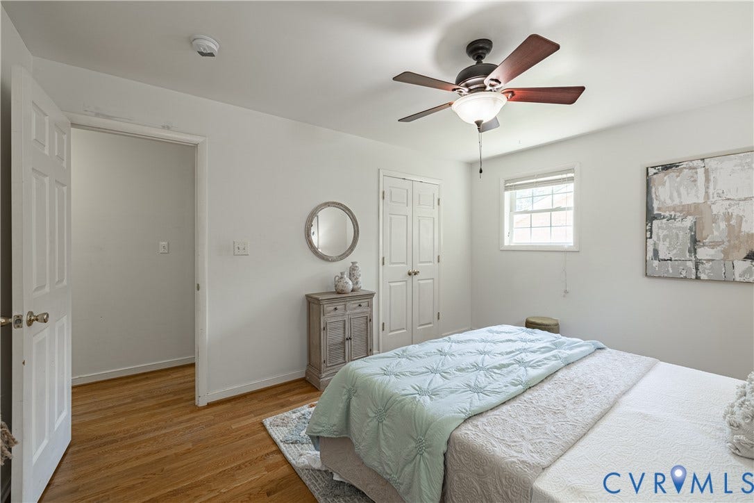 704 Forestview Drive, Colonial Heights, VA 23834 Bright bedroom featuring wood-finish flooring, a ceiling fan with integrated lighting, a double-door closet, and a window with blinds