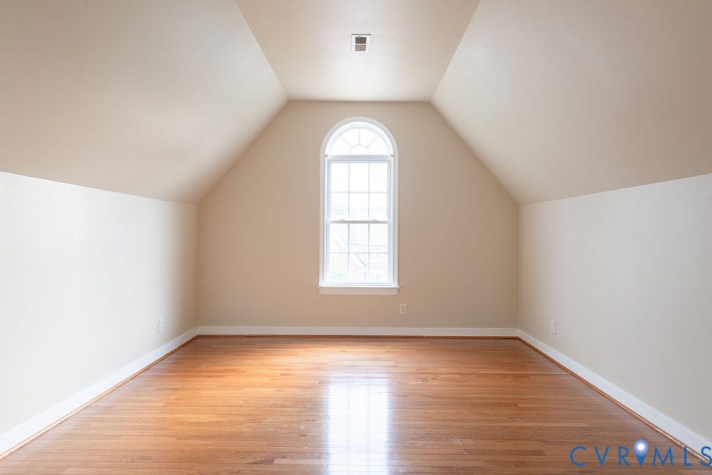 4924 Sadler Glen Ct, Sadler Glen, Glen Allen, VA 23060 Room featuring a prominent arched window, wood-finish flooring, vaulted ceiling, and neutral wall paint
