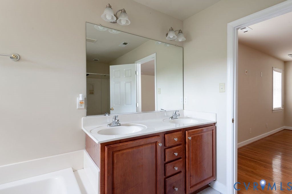 4924 Sadler Glen Ct, Sadler Glen, Glen Allen, VA 23060 Dual vanity featuring wood-finish cabinetry, white countertop, and integrated sinks
