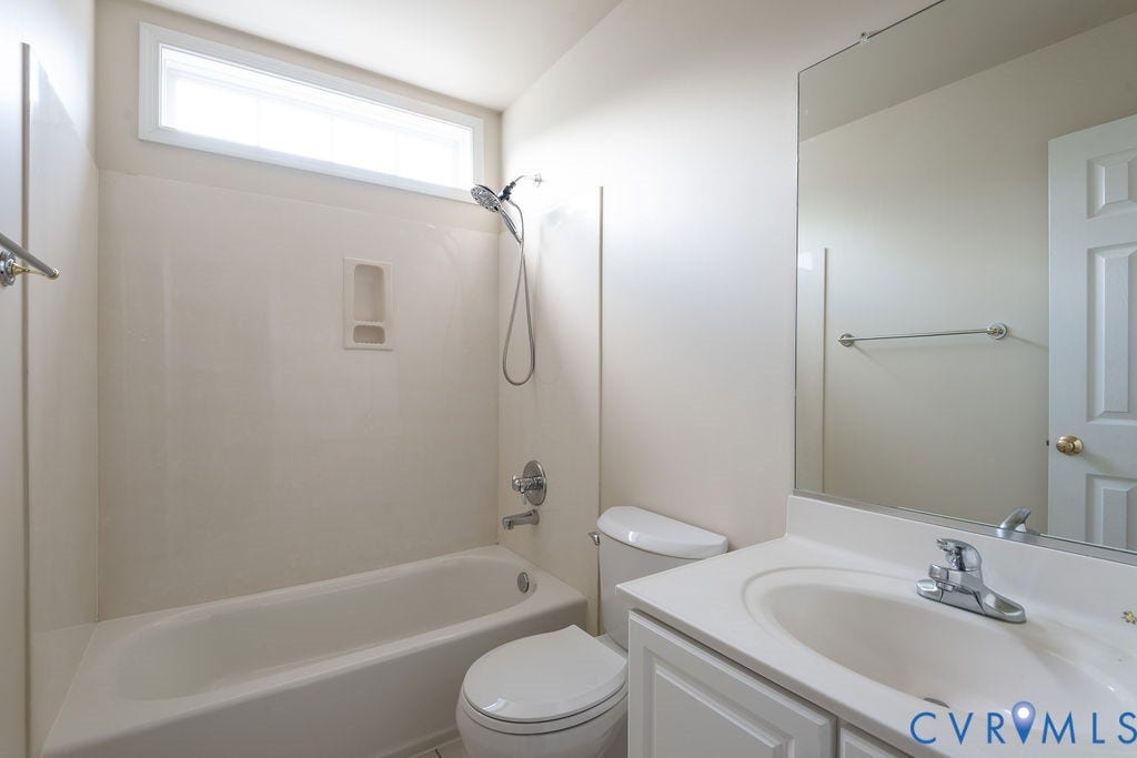 4924 Sadler Glen Ct, Sadler Glen, Glen Allen, VA 23060 White bathroom featuring a bathtub with an integrated shower, a white toilet, and a vanity with a white countertop and sink