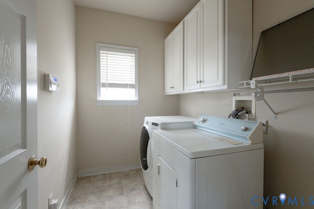 4924 Sadler Glen Ct, Sadler Glen, Glen Allen, VA 23060 Dedicated laundry area featuring a window, overhead cabinetry, and vinyl flooring