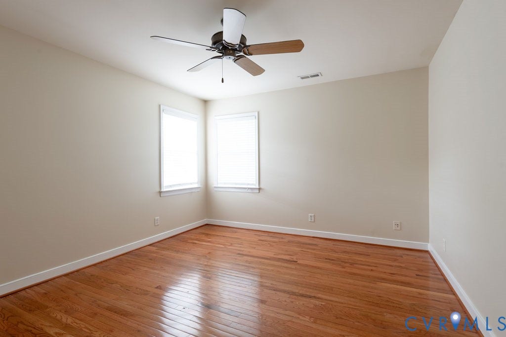 4924 Sadler Glen Ct, Sadler Glen, Glen Allen, VA 23060 Room featuring wood-finish flooring, two windows with blinds, a ceiling fan with integrated lighting, and neutral wall paint