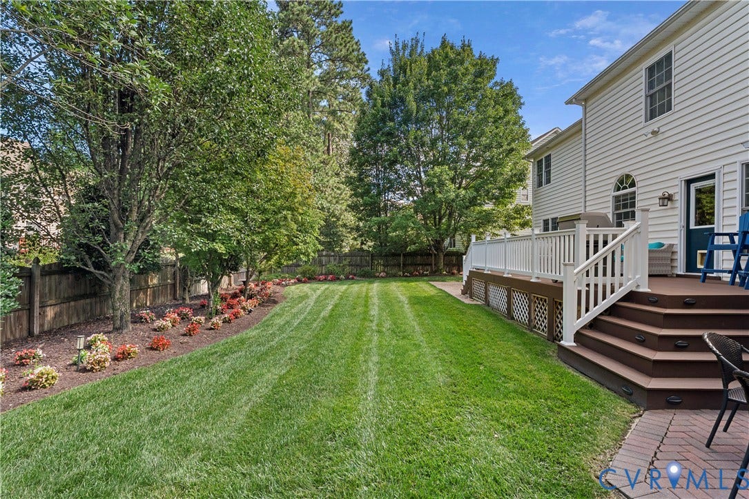 5009 Sadler Place Terrace, Glen Allen, VA 23060 Fenced backyard with manicured lawn and mature landscaping