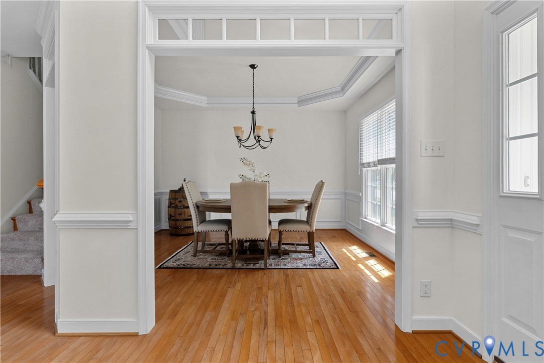 5009 Sadler Place Terrace, Glen Allen, VA 23060 Dining Room features hardwood flooring, doorway transom, tray ceiling, chandelier, and picture molding