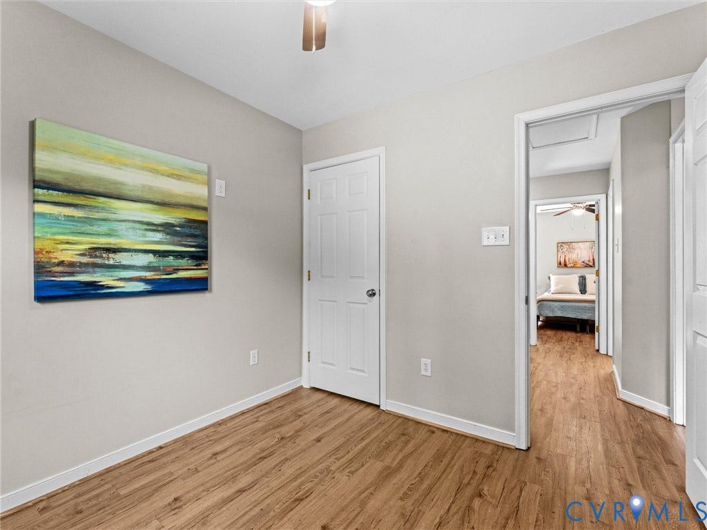 10100 Robin Lee Lane, Laurel Lakes, Glen Allen, VA 23060 Interior room featuring wood-finish flooring, light neutral wall paint, and white baseboards