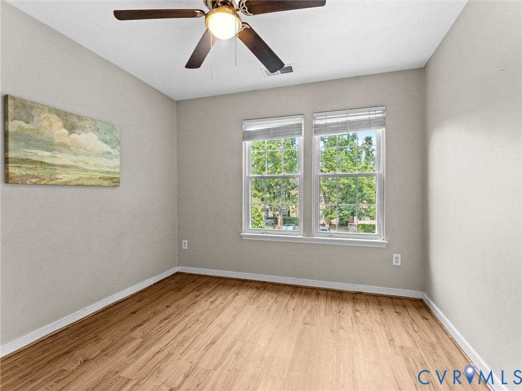 10100 Robin Lee Lane, Laurel Lakes, Glen Allen, VA 23060 Room featuring wood-finish flooring, two large windows with blinds, a ceiling fan with integrated lighting, and neutral wall tones
