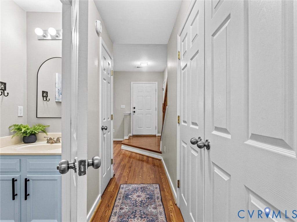 10100 Robin Lee Lane, Laurel Lakes, Glen Allen, VA 23060 Hallway featuring wood-finish flooring, white paneled doors, and a decorative runner