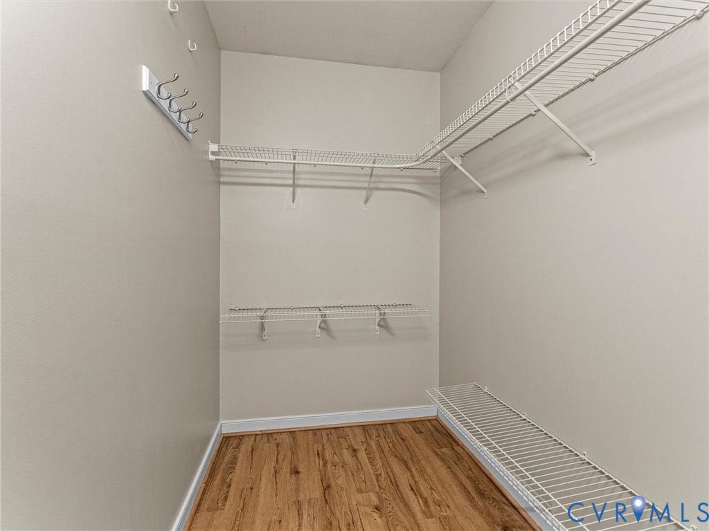 10100 Robin Lee Lane, Laurel Lakes, Glen Allen, VA 23060 Walk-in closet featuring wood-finish flooring, white wire shelving, and wall-mounted coat hooks