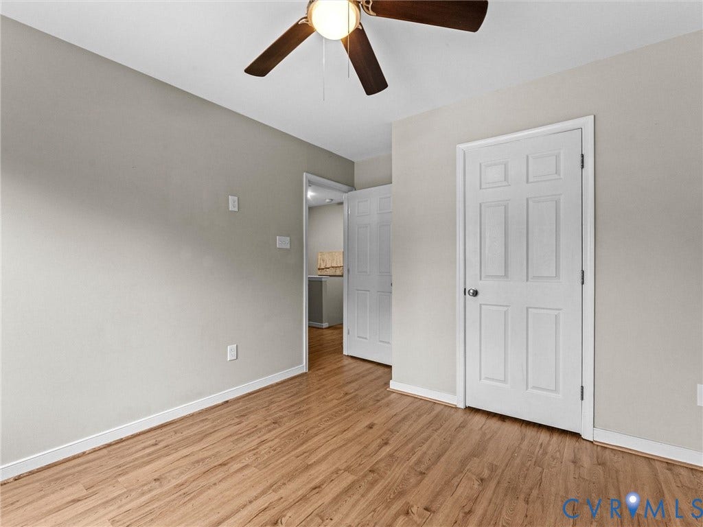 10100 Robin Lee Lane, Laurel Lakes, Glen Allen, VA 23060 Room featuring wood-finish flooring, light neutral wall color, white baseboards, and a ceiling fan with integrated lighting