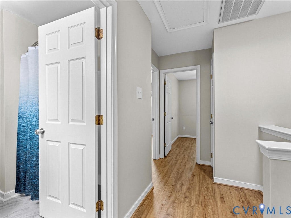 10100 Robin Lee Lane, Laurel Lakes, Glen Allen, VA 23060 Hallway featuring wood-finish flooring, light neutral wall paint, and white trim molding