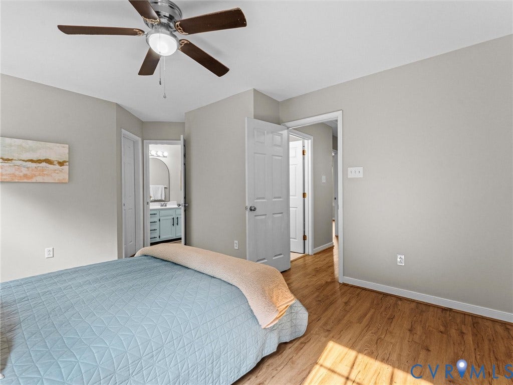10100 Robin Lee Lane, Laurel Lakes, Glen Allen, VA 23060 Bedroom featuring wood-finish flooring, light grey painted walls, and a ceiling fan with integrated lighting