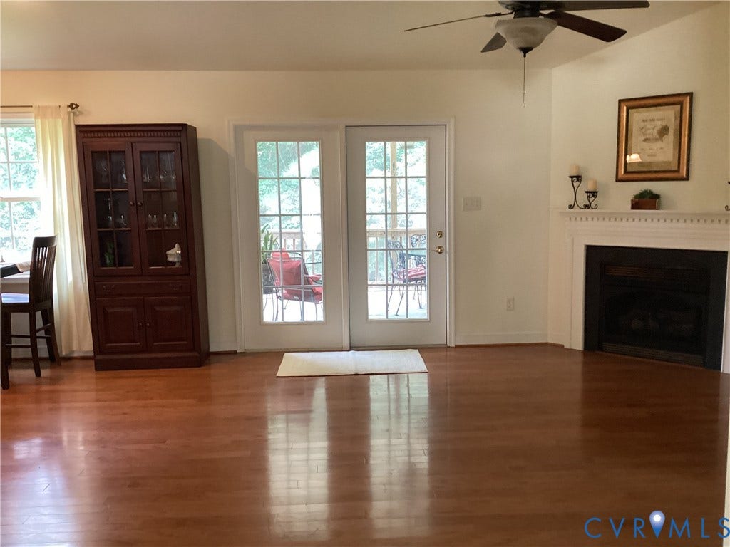 11611 Hillside Road, Chester, VA 23831 Greatroom features open floor plan, with wood floors, gas fireplace, French doors leading to screened porch.