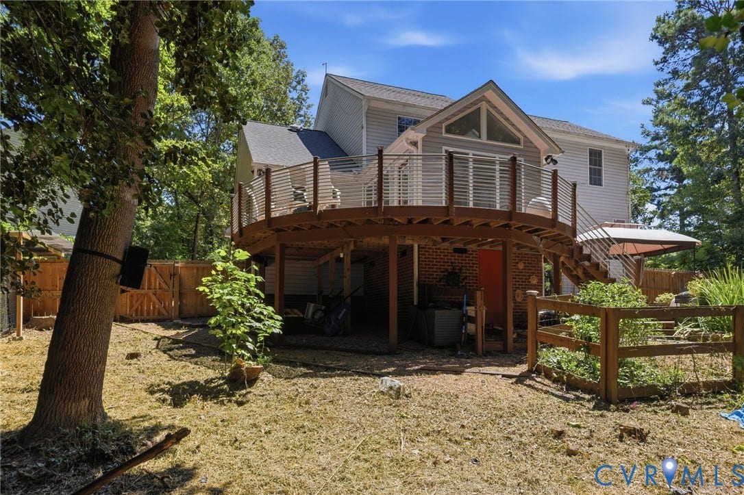 5215 Lippingham Lane, Stoney Glen West, Chester, VA 23831 Expansive rear exterior featuring a multi-level deck with cable railing, a ground-level patio space, and mature perimeter trees