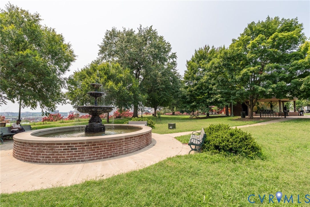 2016 Princess Anne Avenue, Union Hill, Richmond, VA 23223 Tiered fountain with a brick basin, surrounded by mature trees and manicured lawns, concrete pathways, and park benches- Jefferson Park