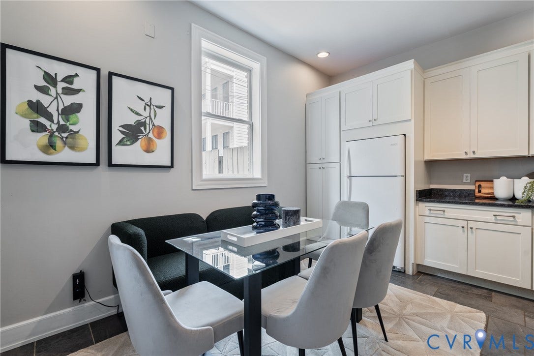 2016 Princess Anne Avenue, Union Hill, Richmond, VA 23223 Dining area featuring a glass-top table, integrated kitchen cabinetry, dark stone countertops, and recessed lighting