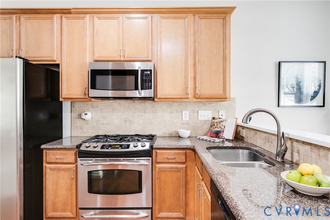 8004 Creekside Village Drive, Creekside Village, Mechanicsville, VA 23111 Kitchen featuring wood cabinetry, stainless steel appliances, granite countertops, tile backsplash, and a double basin sink with a gooseneck faucet