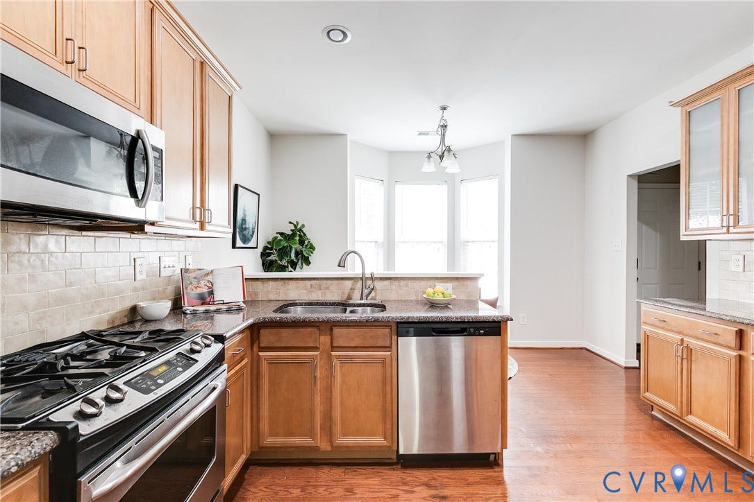 8004 Creekside Village Drive, Creekside Village, Mechanicsville, VA 23111 Kitchen featuring stainless steel appliances, wood-finish flooring, recessed lighting, bay windows, and light wood cabinetry