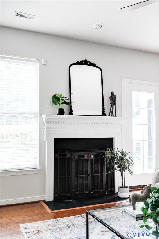 8004 Creekside Village Drive, Creekside Village, Mechanicsville, VA 23111 Fireplace featuring a classic white mantel, black fire screen, and dark hearth
