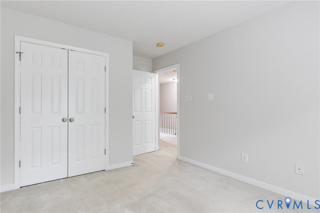 8004 Creekside Village Drive, Creekside Village, Mechanicsville, VA 23111 Carpeted interior space with light gray walls, white baseboards, and a white six-panel bifold closet door