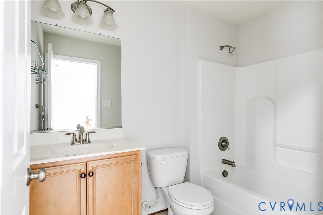 8004 Creekside Village Drive, Creekside Village, Mechanicsville, VA 23111 Bathroom featuring a vanity with light wood cabinetry, white countertop, and brushed nickel fixtures