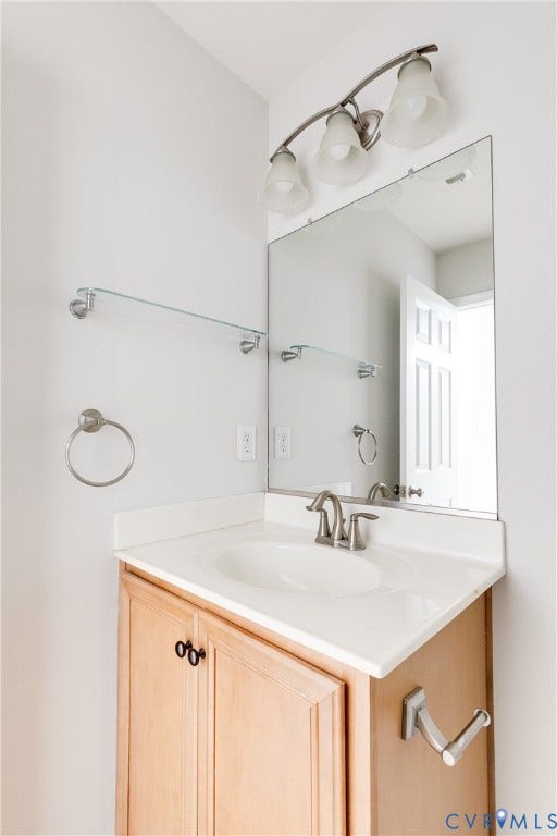 8004 Creekside Village Drive, Creekside Village, Mechanicsville, VA 23111 Bathroom vanity featuring a single basin sink, light-toned cabinetry, and a rectangular mirror
