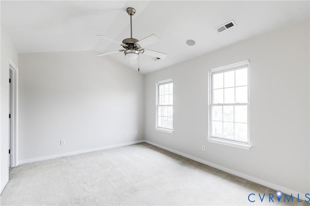 8004 Creekside Village Drive, Creekside Village, Mechanicsville, VA 23111 Carpeted room featuring a ceiling fan with integrated lighting, two double-hung windows, a ceiling-mounted speaker, and white baseboards