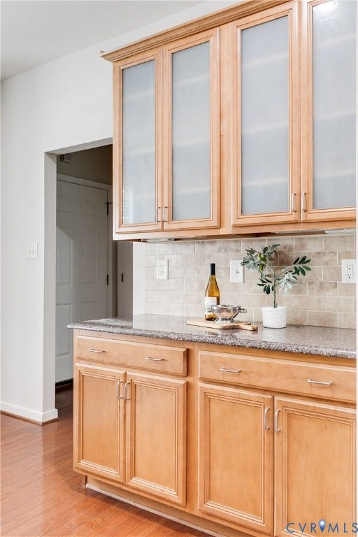 8004 Creekside Village Drive, Creekside Village, Mechanicsville, VA 23111 Kitchen featuring light wood-finish cabinetry with frosted glass upper doors, granite-style countertops, and a neutral-toned tile backsplash