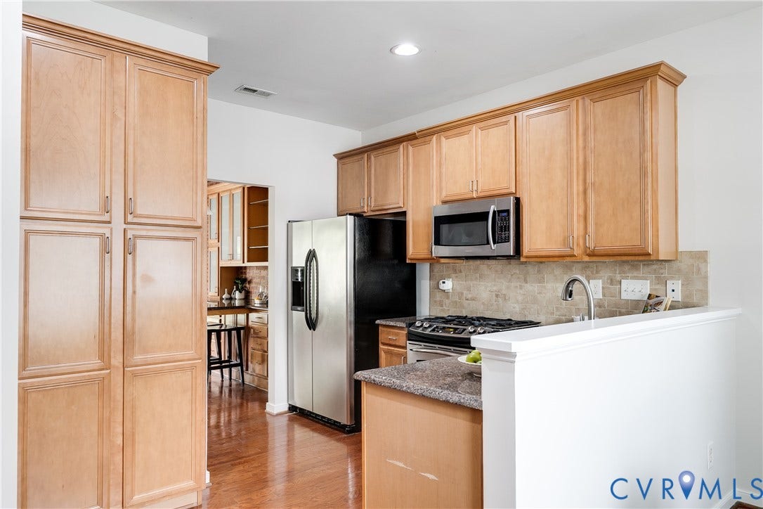 8004 Creekside Village Drive, Creekside Village, Mechanicsville, VA 23111 Kitchen featuring wood-finish cabinetry, stainless steel appliances, granite-style countertops, and a tiled backsplash