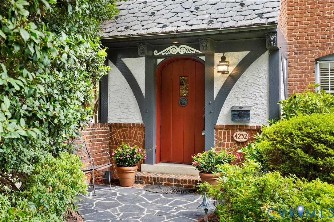 Heavy arched door welcomes you.