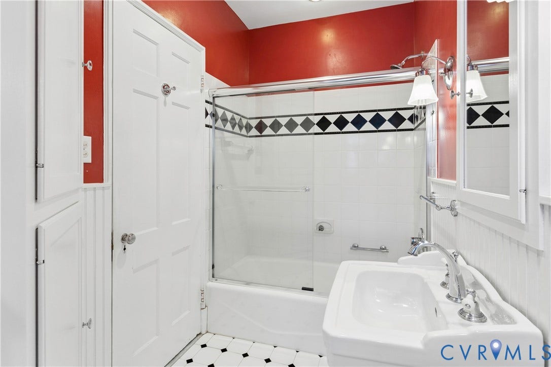Tub/shower combo, ceramic tile and built in storage as well as a medicine cabinet.