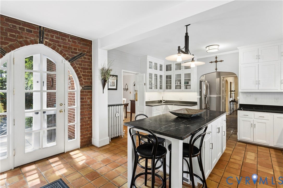 Island has room for 4 chairs. Note prep sink in corner.   Beautiful door opens to courtyard and patio.