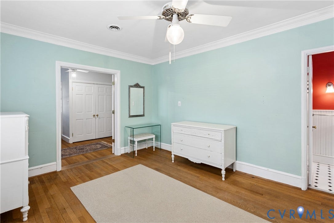 Double door leads to a sitting area and more closets.