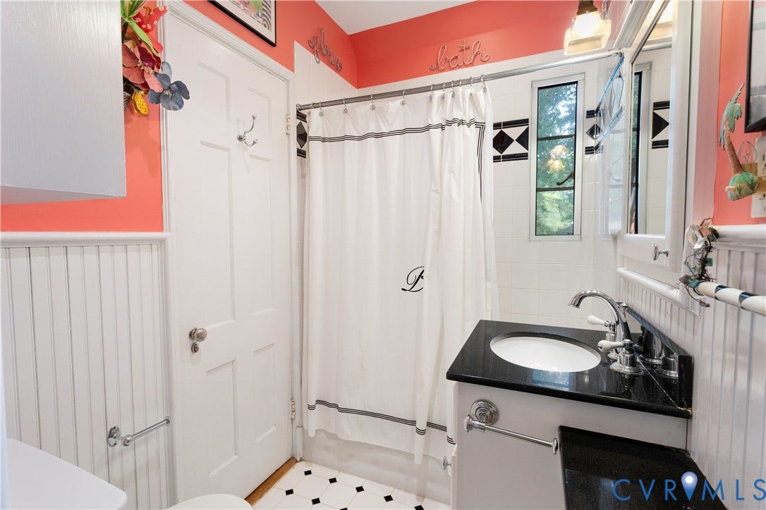 Second floor full bath.  Tub/shower combo, ceramic tile and bead board wainscotting.