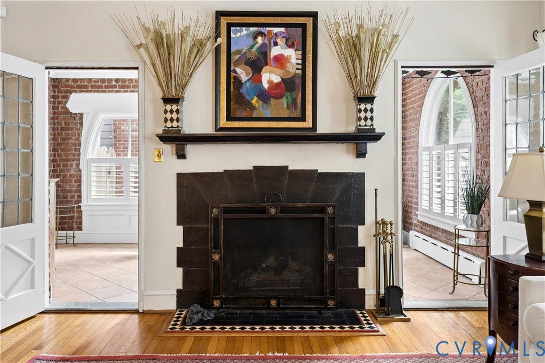 Masonry fireplace with gas logs. Doors lead to sun porch
