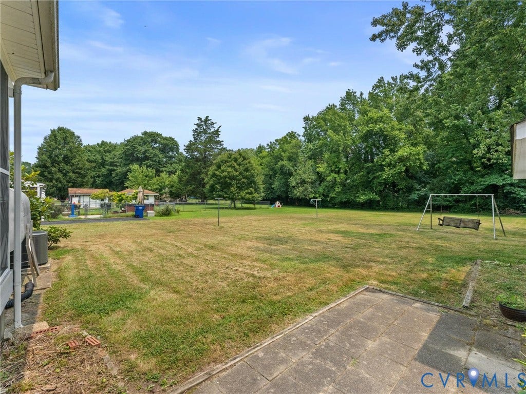 9633 Shamrock Drive, Centralia Gardens/Salem Woods, Chesterfield, VA 23237 Expansive rear yard featuring a large grass area, mature perimeter trees, and a concrete paver patio