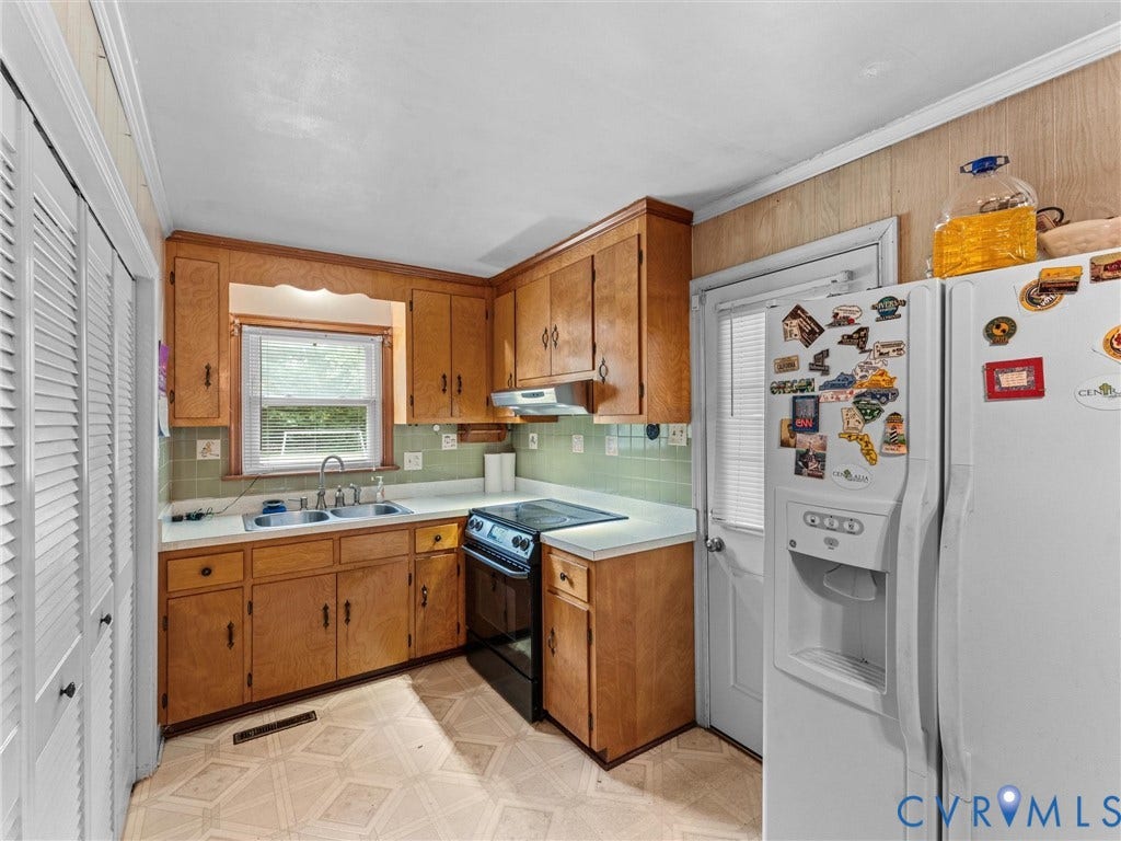 9633 Shamrock Drive, Centralia Gardens/Salem Woods, Chesterfield, VA 23237 Kitchen featuring wood-finish cabinetry, light-toned countertops, a stainless steel double sink, a black electric range, and light-colored flooring