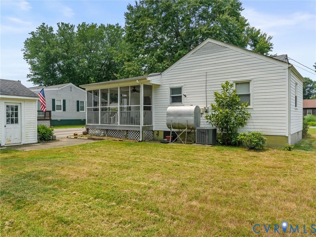 9633 Shamrock Drive, Centralia Gardens/Salem Woods, Chesterfield, VA 23237 Expansive backyard featuring a screened porch with a ceiling fan, a detached shed with a panel door, white vinyl siding, and established landscaping