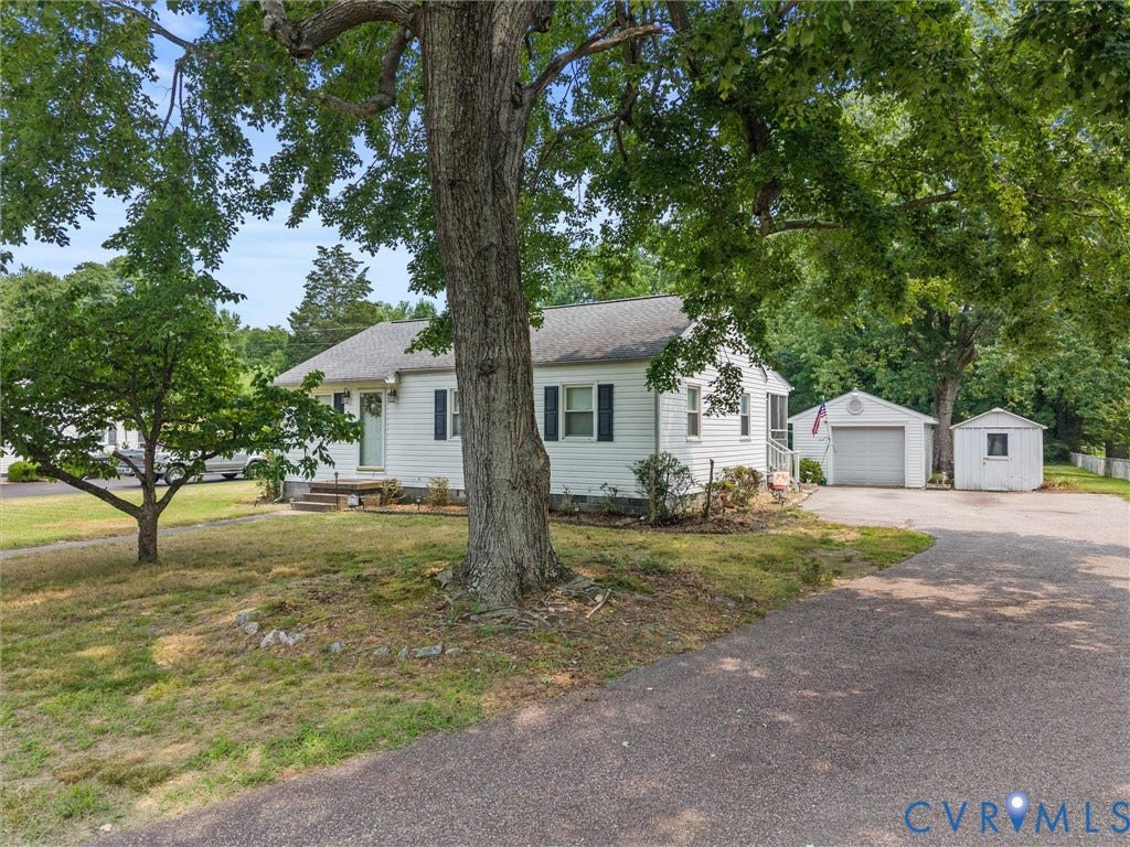 9633 Shamrock Drive, Centralia Gardens/Salem Woods, Chesterfield, VA 23237 White siding residence featuring a paved driveway, detached garage, and an additional shed